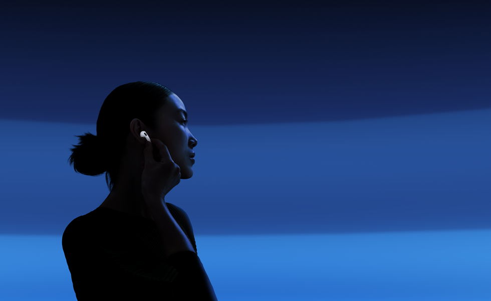 En person skifter lyttefunktion ved at holde tommel- og pegefingeren på staven på sine AirPods 5